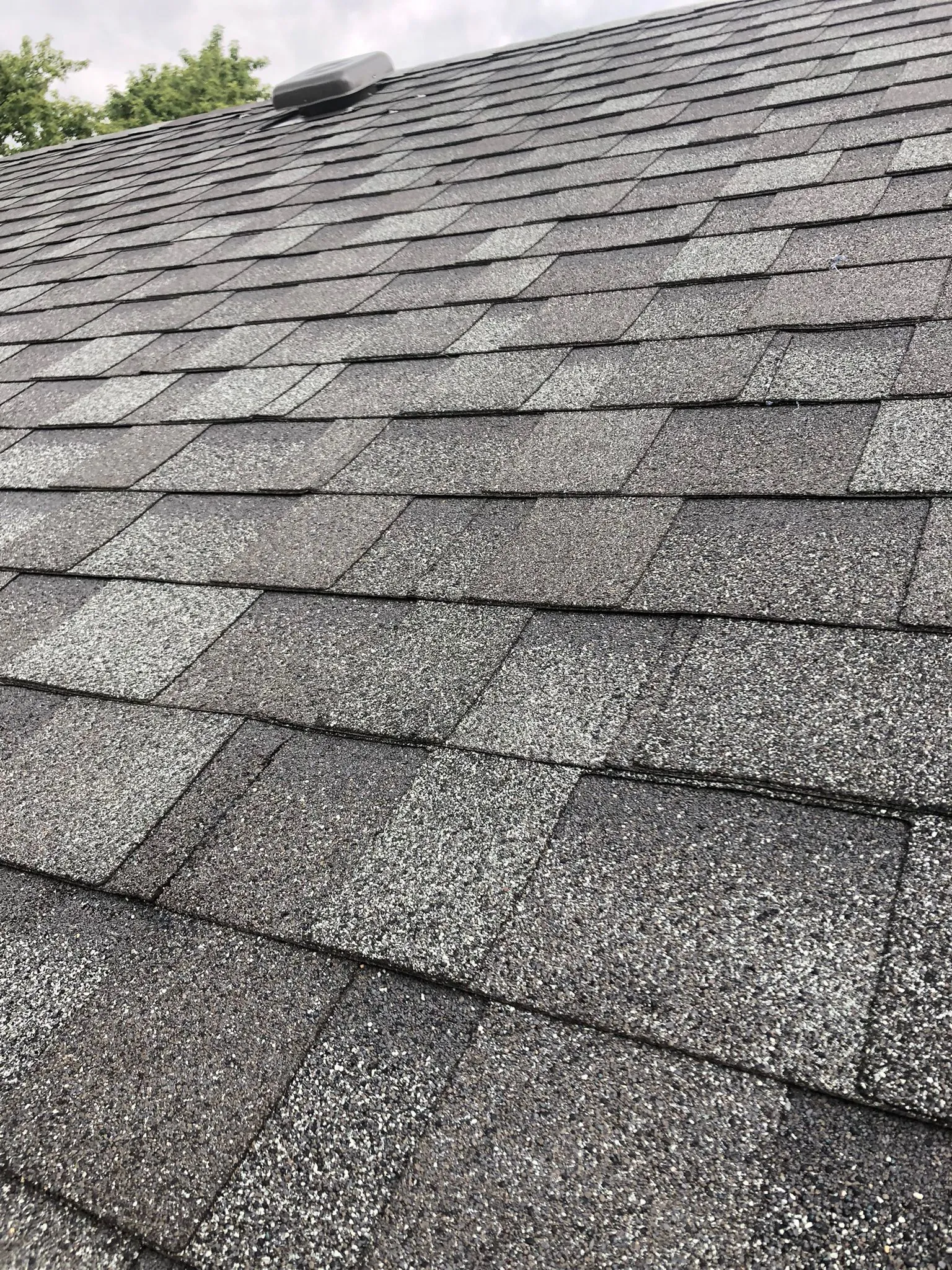 close up to newly layed mix of square and rectangle shingle roofing