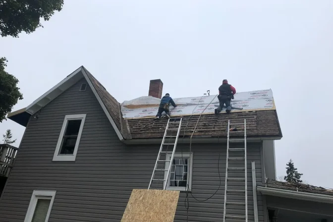 roofing contractor team repairing old shingle roofing