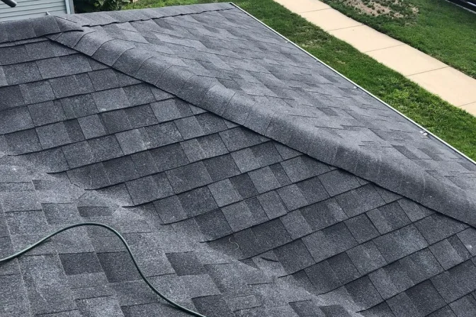 newly layed grey asphalt shingles on the roof