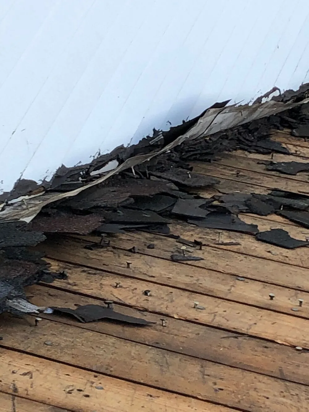 old broken shingles removed from the roof