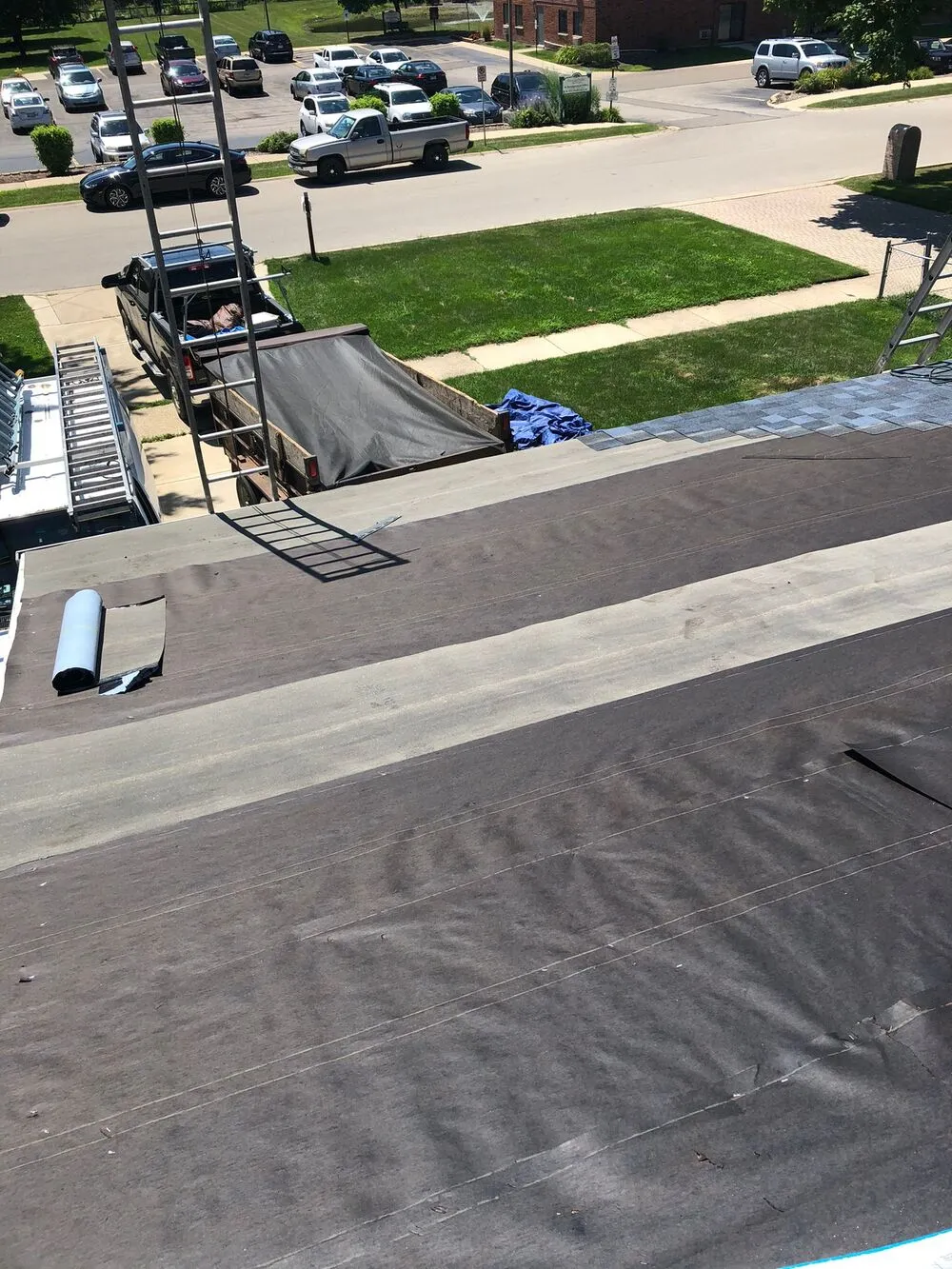 process of laying new shingle roofing on the house