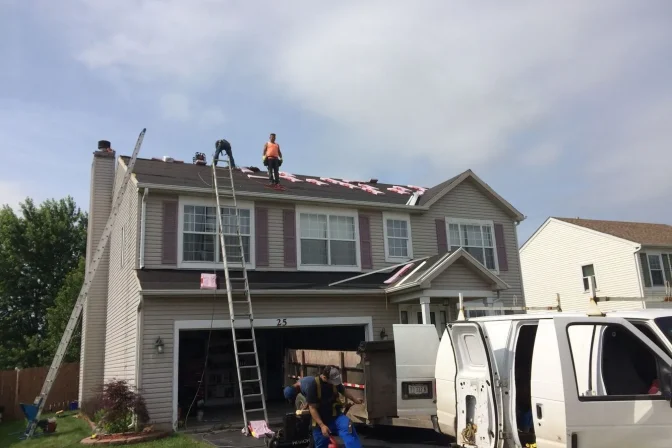 house exterior and roofing contractor team working one the new roof installation