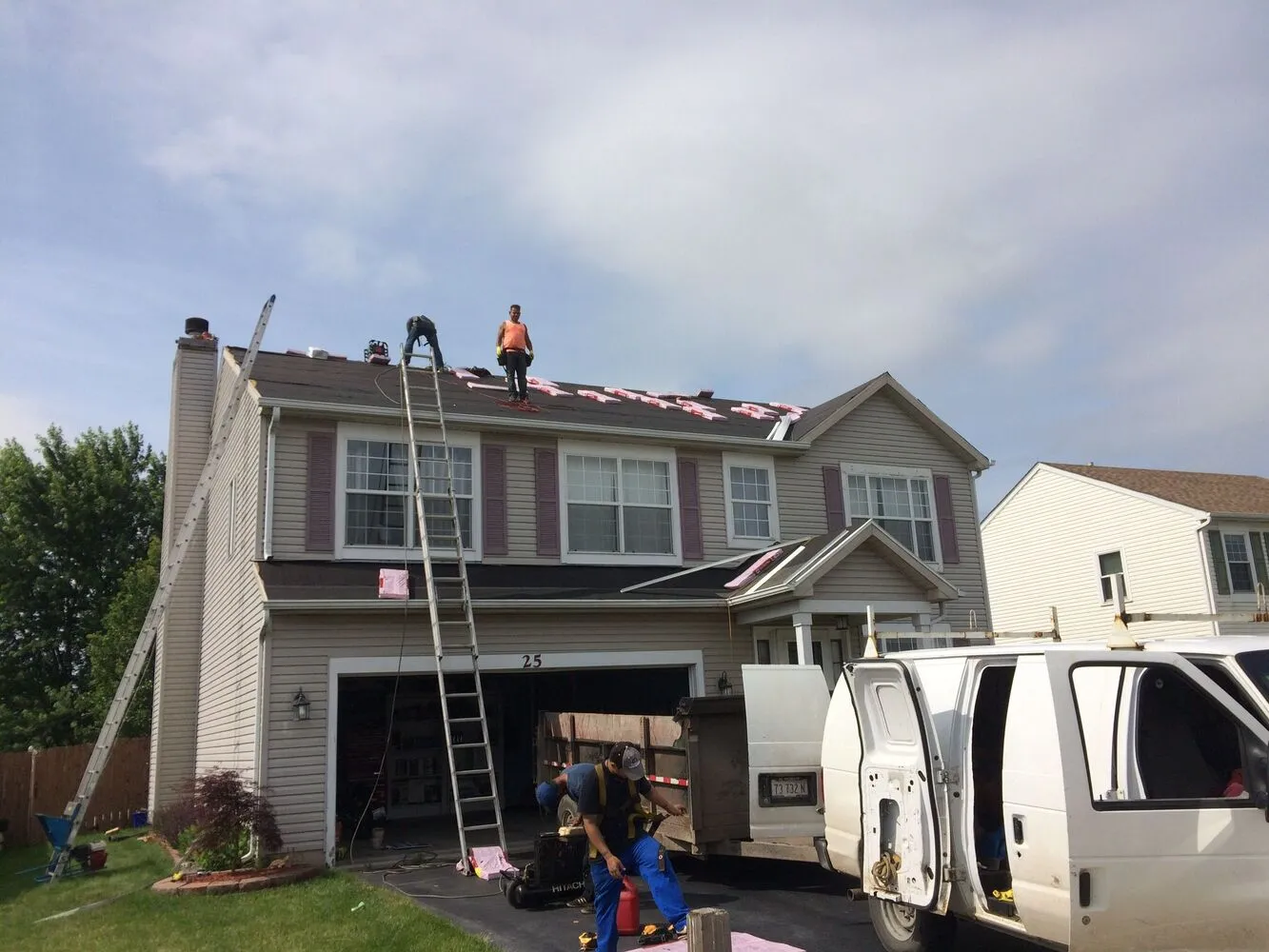 house exterior and roofing contractor team working one the new roof installation