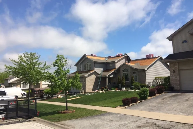 huge house during shingle roofing installation process